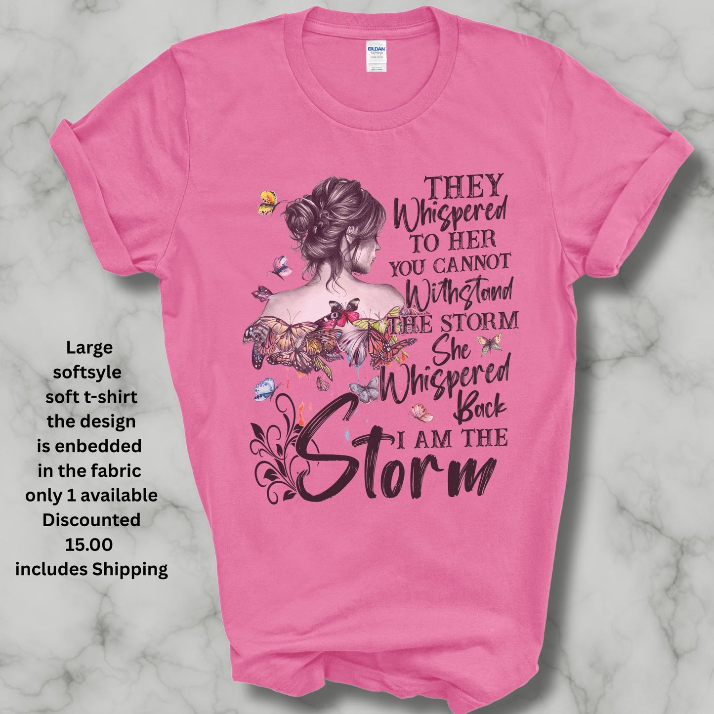 Large soft pink t shirt saying they whispered to her you cannot stand the storm she whispered back I am the storm in black letters has colored butterflies with dripping color spots and a women in a bun heavly discounted ishipping included in the price 