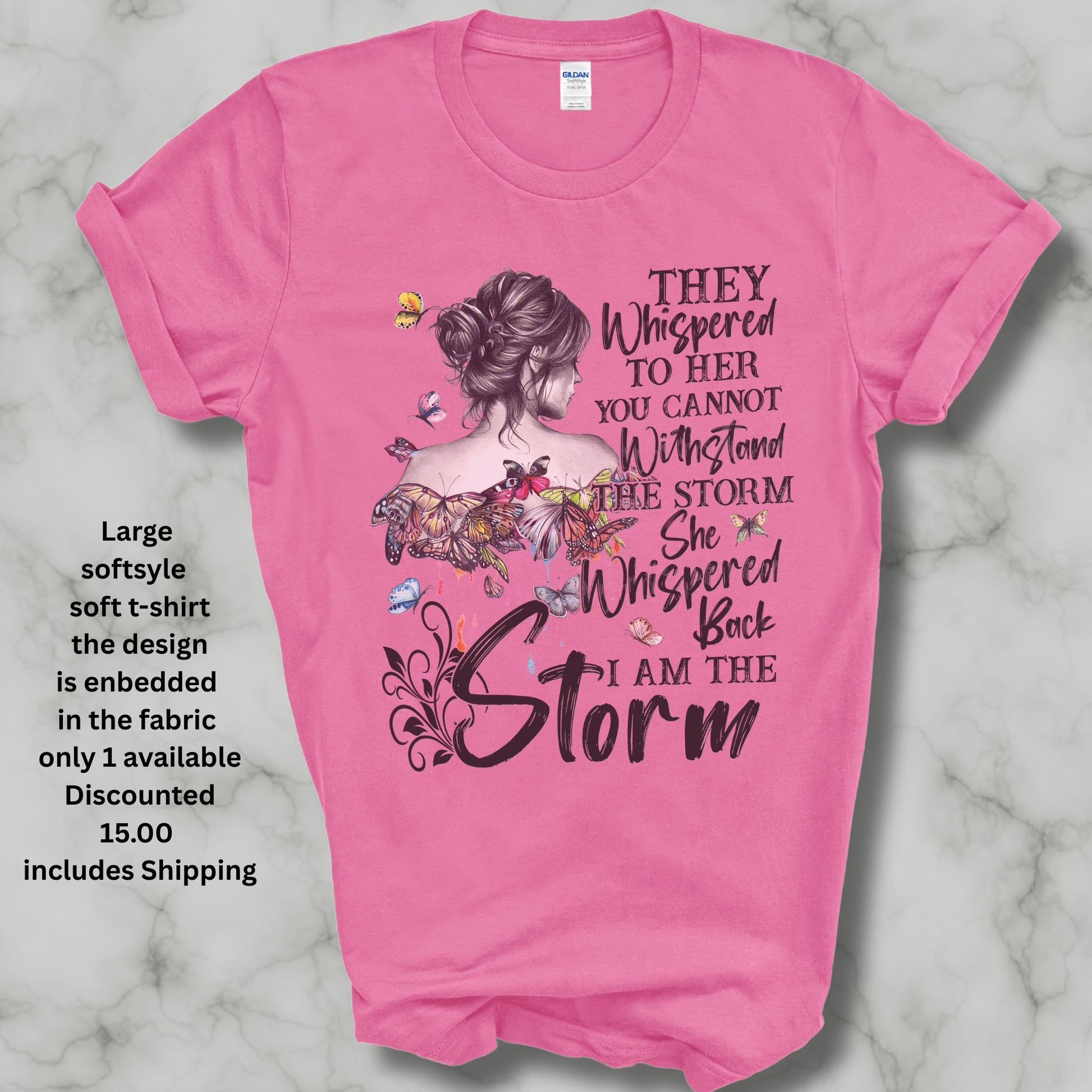 Large soft pink t shirt saying they whispered to her you cannot stand the storm she whispered back I am the storm in black letters has colored butterflies with dripping color spots and a women in a bun heavly discounted ishipping included in the price 